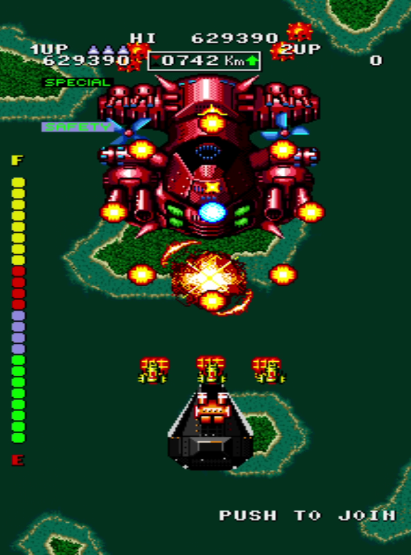 Mid-boss battle with large red enemy about one-third screen height