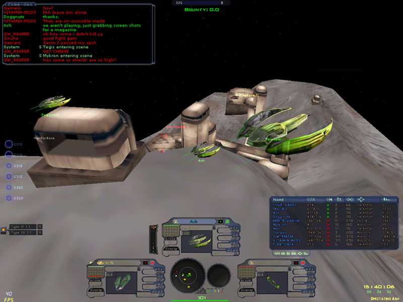 Screenshot: green fighters docked at a station built on an asteroid