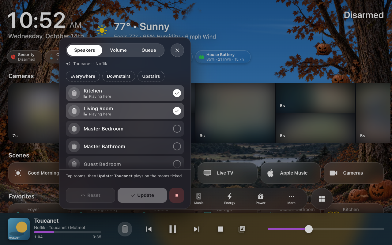 The Now Playing bar's Speakers panel open above its button: Speakers, Volume and Queue