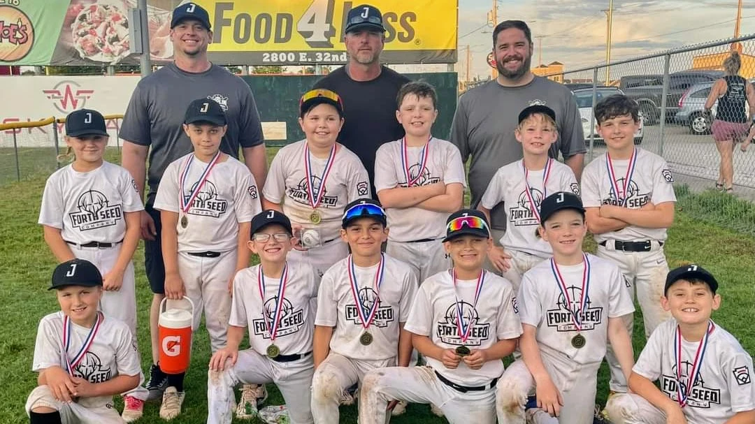 2022 undefeated youth baseball championship team with trophies at Joplin Family Festival tournament