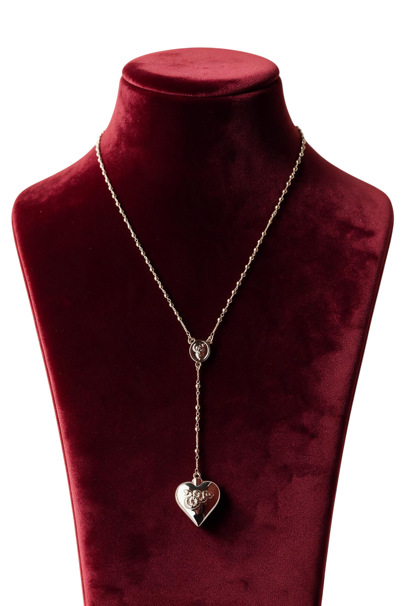 Gold heart and spoon necklace displayed on a burgundy velvet bust