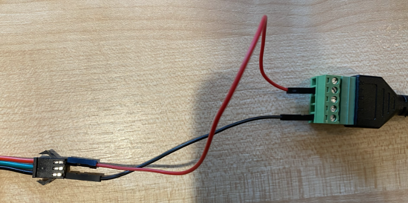 The red wire going into the connector on the LEDs connected the positive terminal of the power supply, and the black wire going into the connector connected to the negative terminal