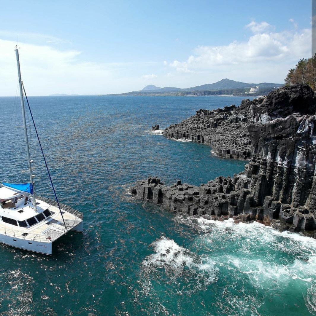 Jeju sailing yacht and coastline
