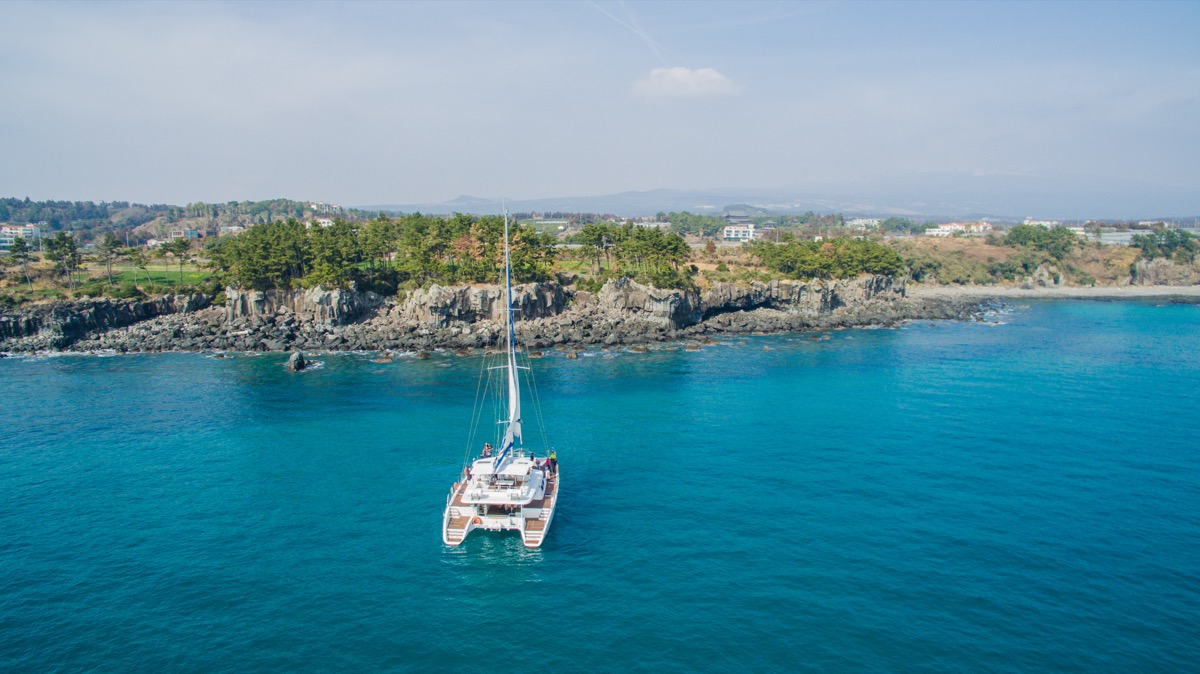 Jeju sailing yacht and coastline