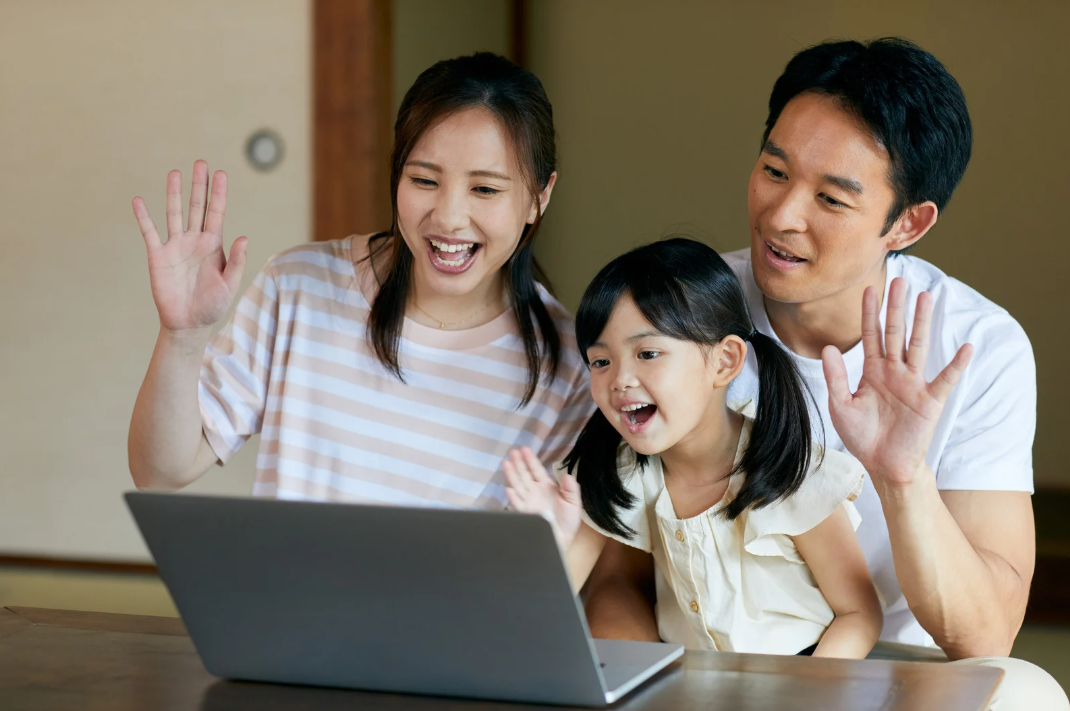 Family learning together on a laptop