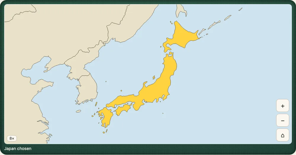 The demo's Explore mode on a desk: the world drawn with Japan in the middle and the sea round it, Japan filled yellow because it is chosen, the zoom buttons in the bottom corner and the words Japan chosen under the map