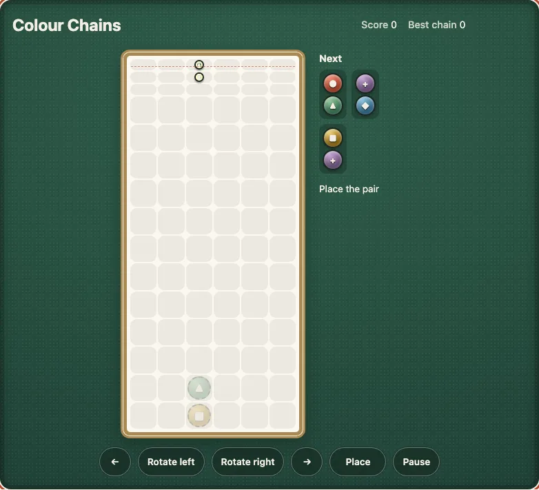 Colour Chains on a desk after six placed pairs: a tall pale well with a heap of gems at the bottom and a pair of gems at the top, the Next pair beside it, and the buttons for the arrows, Rotate left, Rotate right, Place and Pause under it