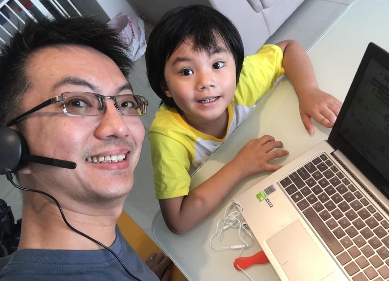 John working from home with his daughter