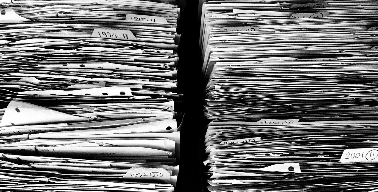 Black and white picture of stacks of old folders