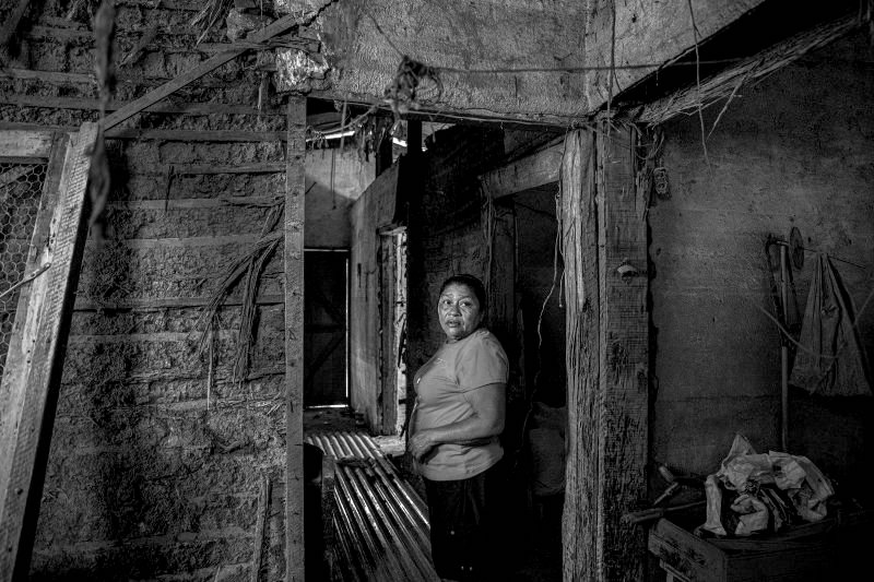 Mercedes Morales walks through what remains of her home in the village of Aldea El Coowle, San Manuel Cortes, Honduras, on April 9, 2021. The house was completely destroyed by hurricanes Eta and Iota in November 2020. Credit: Yael Martínez—Magnum Photos for TIME