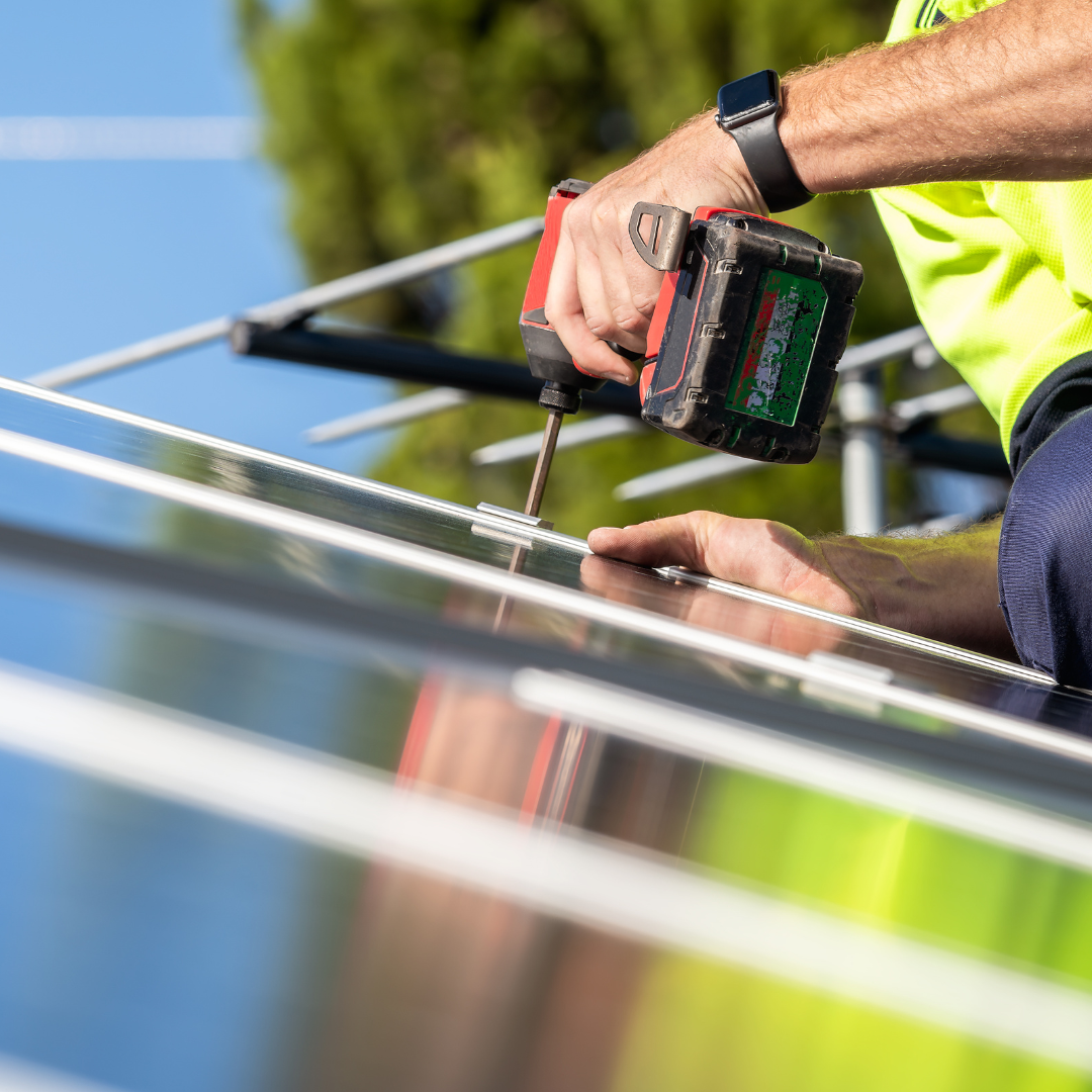 Maintenance technician repairing solar panels on a roof
