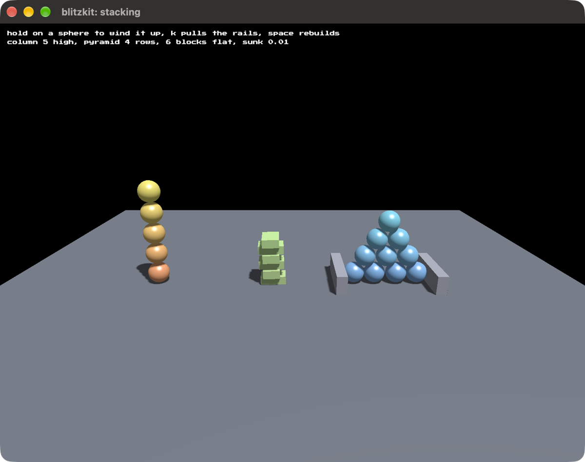 A column of five spheres, a heap of green blocks, and a pyramid of ten spheres on a grey floor