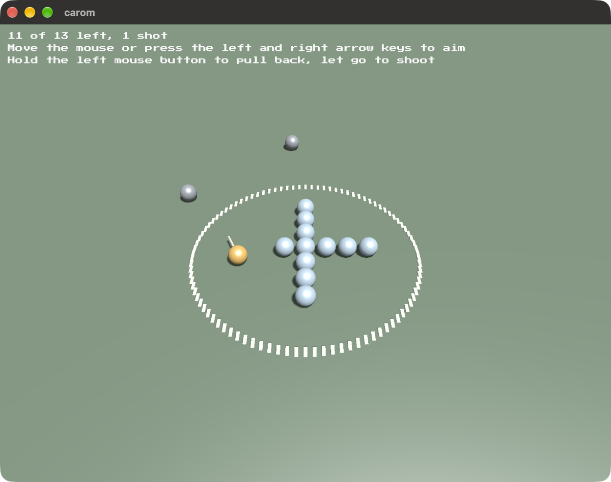 A ring drawn on a green table with eleven pale marbles racked in a cross inside it, an amber shooter against the near arm, and two grey marbles come to rest outside the ring
