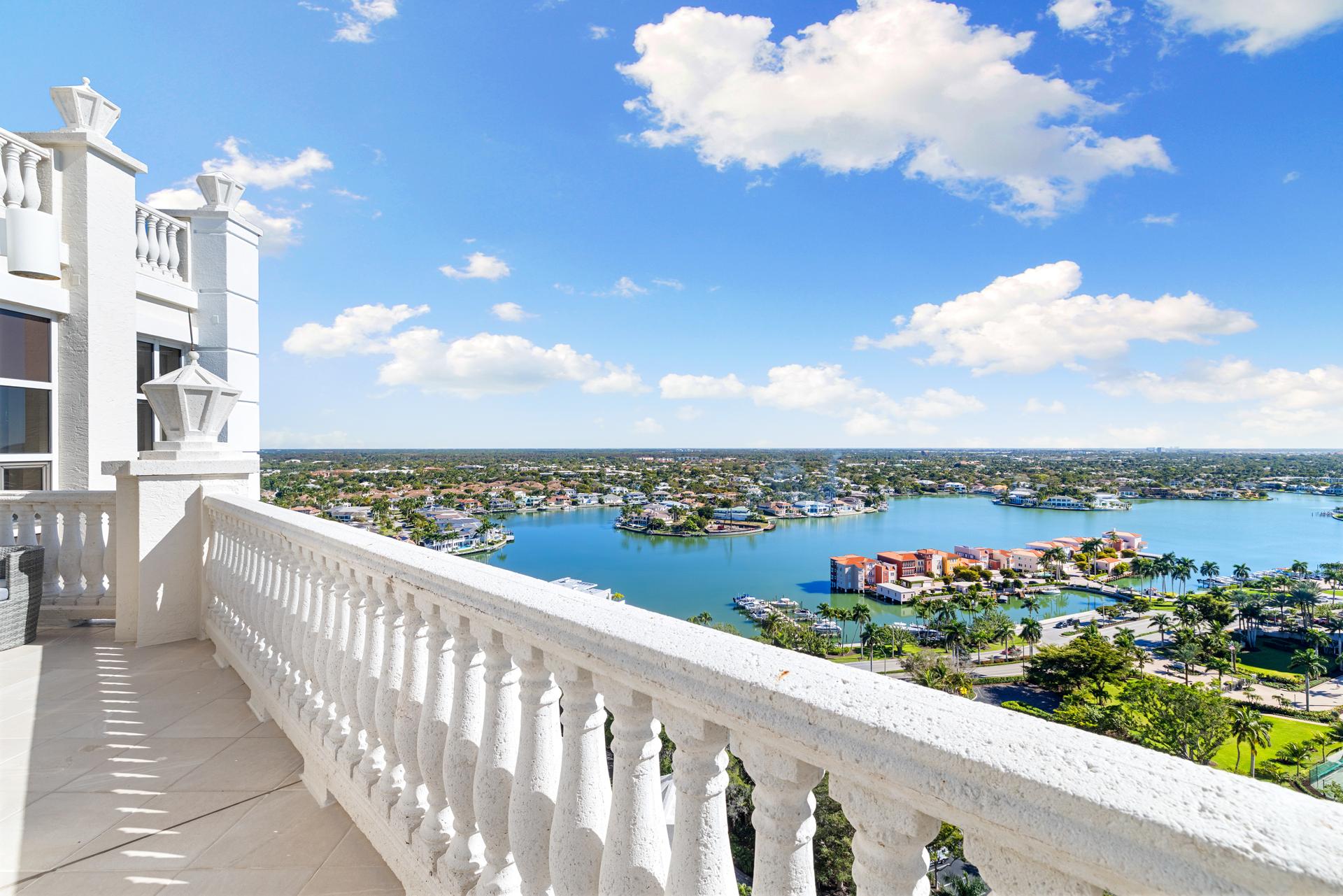 The balustraded wrap-around terrace at 4021 Gulf Shore Blvd N #11, looking out over Venetian Bay and Park Shore