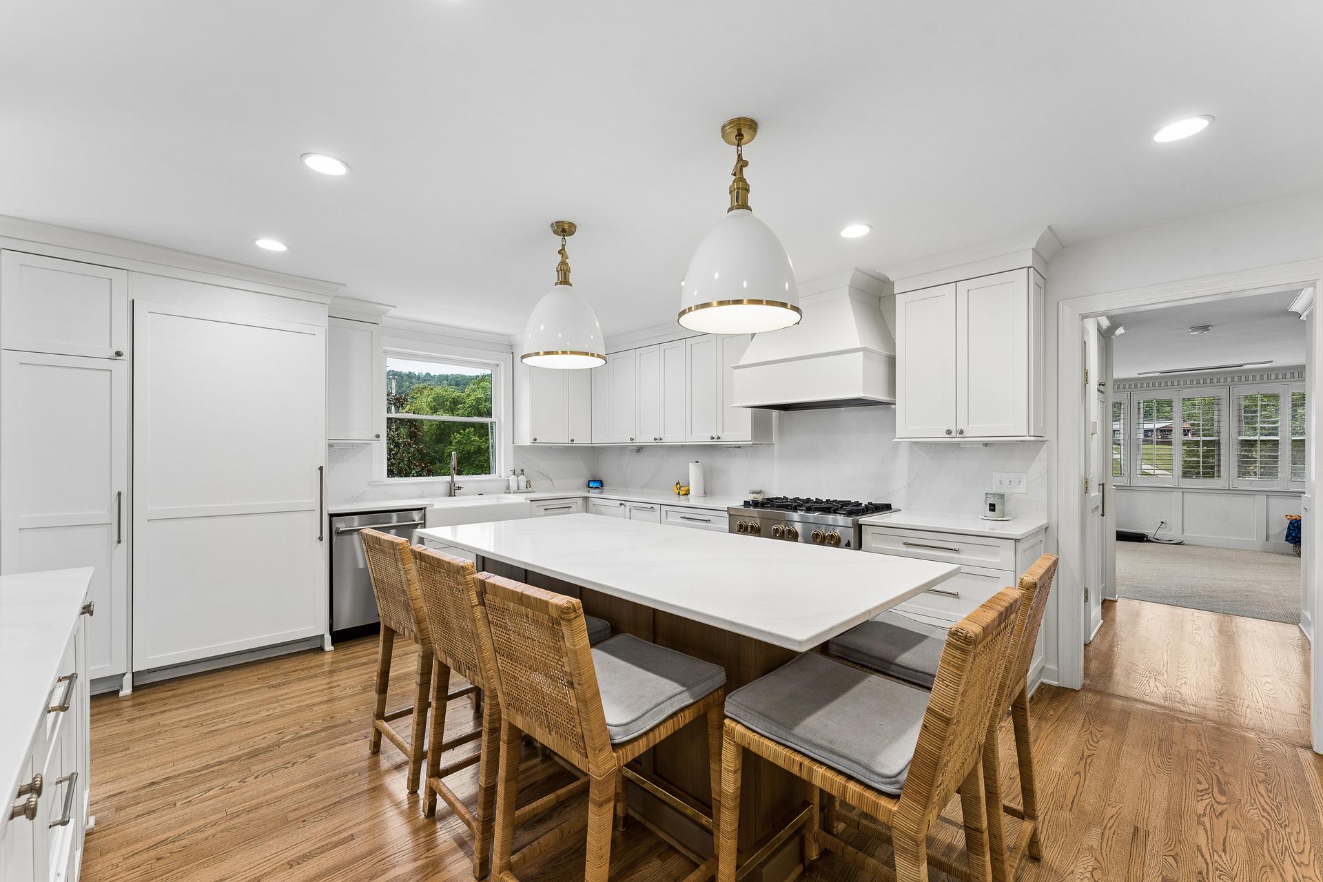 The custom kitchen at 805 Cammack Court, with an oversized island, pendant lighting and custom cabinetry
