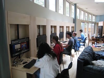 Photo showing that the paneling folds out and monitors slide down to form computer stations.