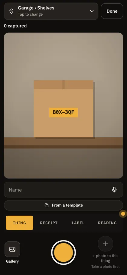 The capture screen on a phone, its camera on a labelled box on the garage shelves