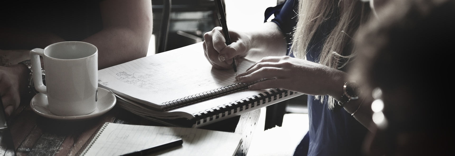 Business meeting and handwritten notes