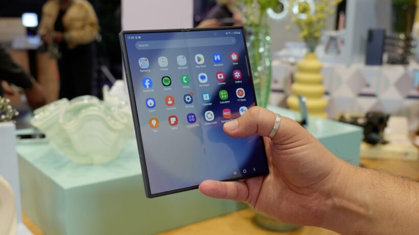 Hand holding an unfolded Samsung foldable smartphone
