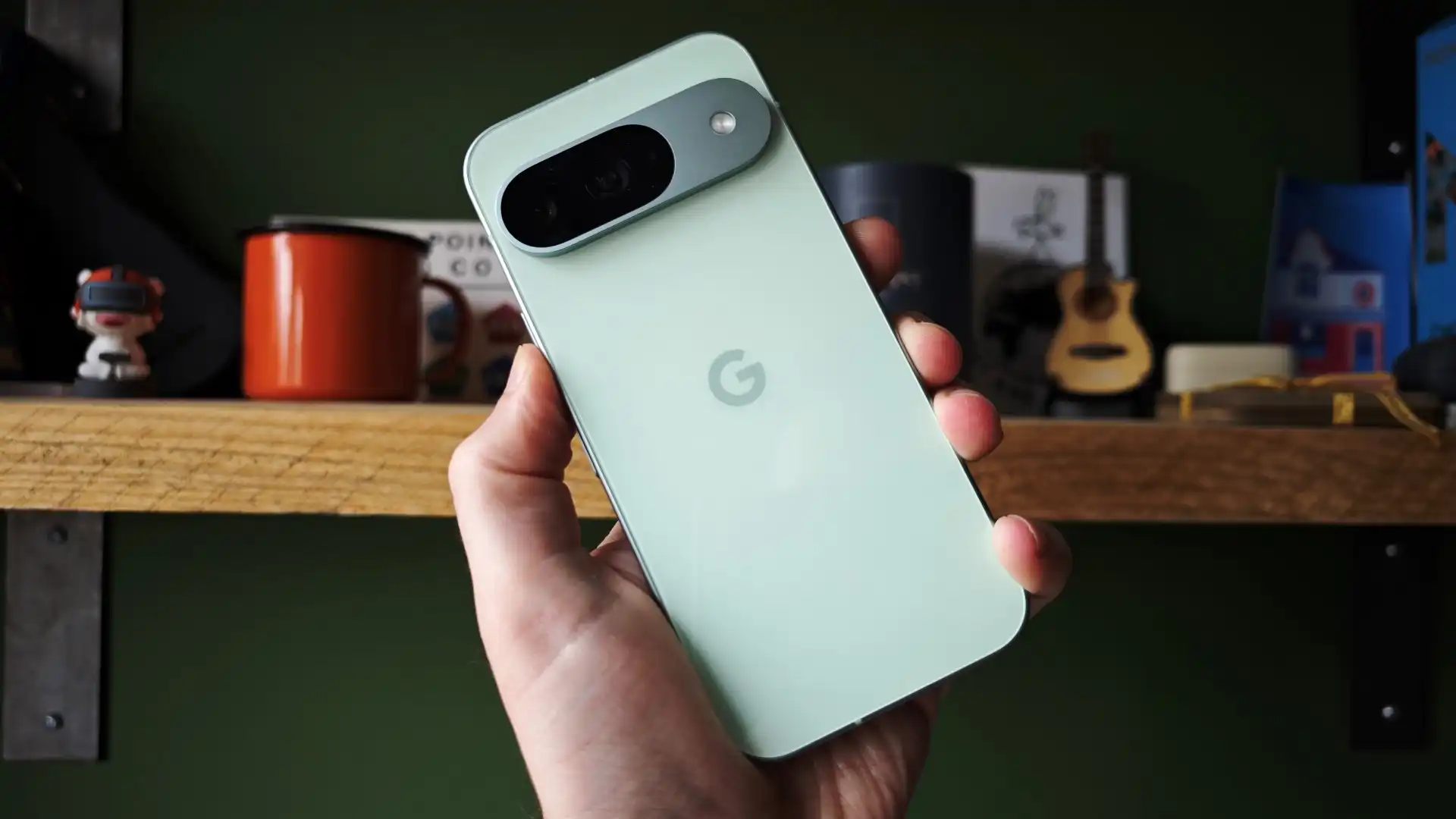Green Google Pixel 7 held in hand