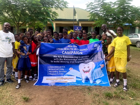 Pupils and staff pose together at the campaign banner