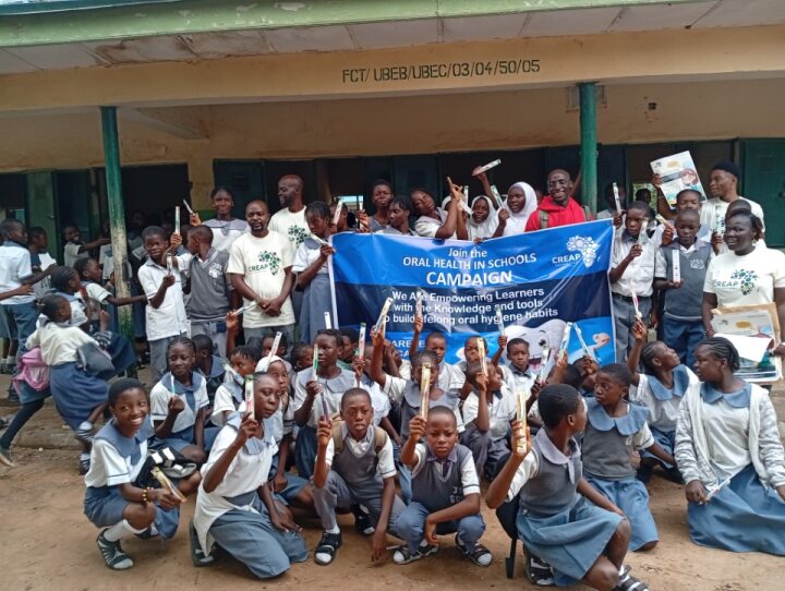 Excited pupils wave their new toothbrushes