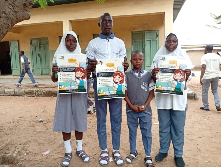 A pupil and teacher share the oral hygiene flyer