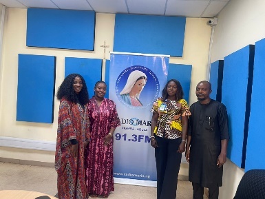 The CREAP team with the Radio Maria FM banner
