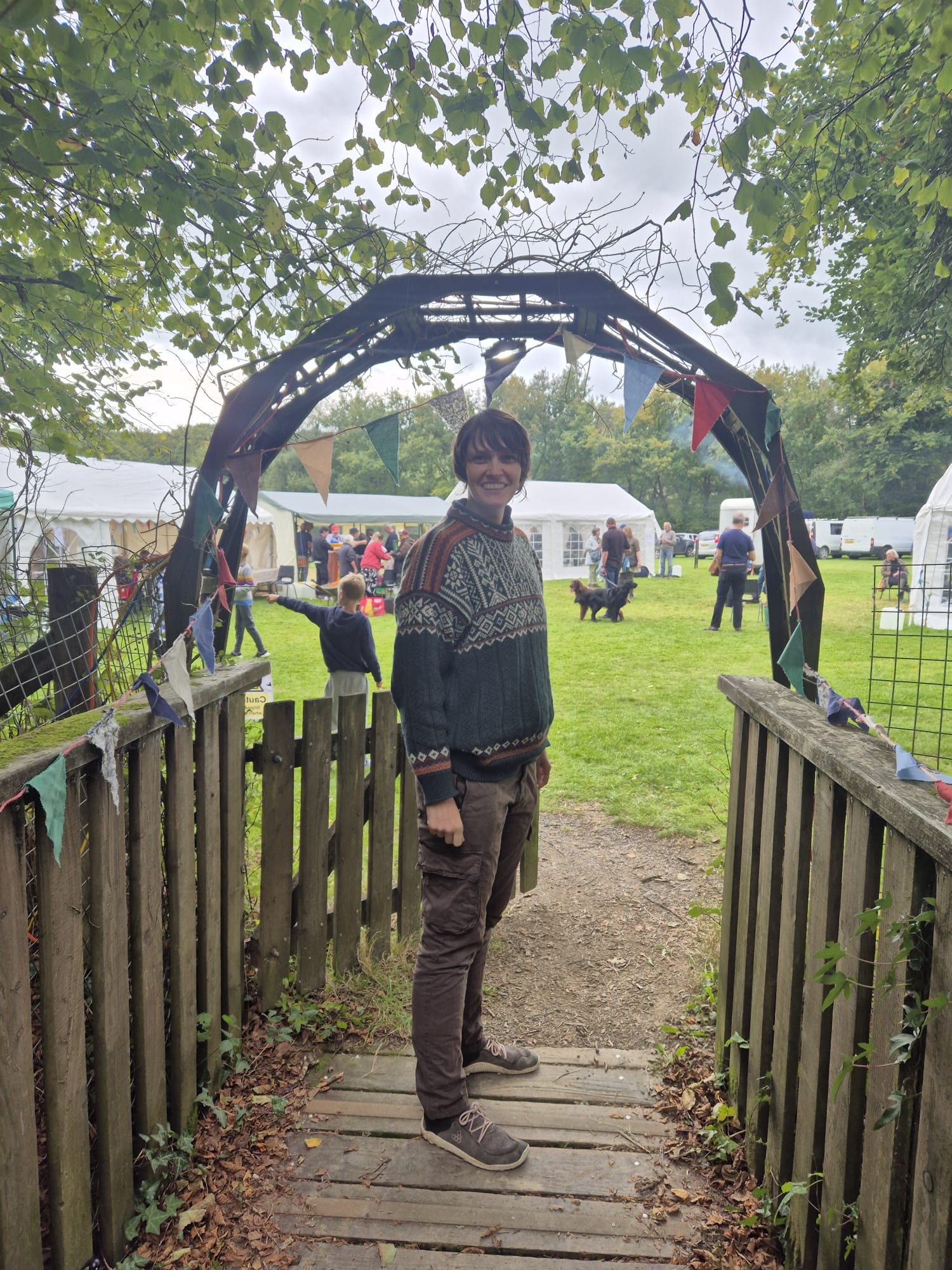 Kirstin standing in an archway to a field