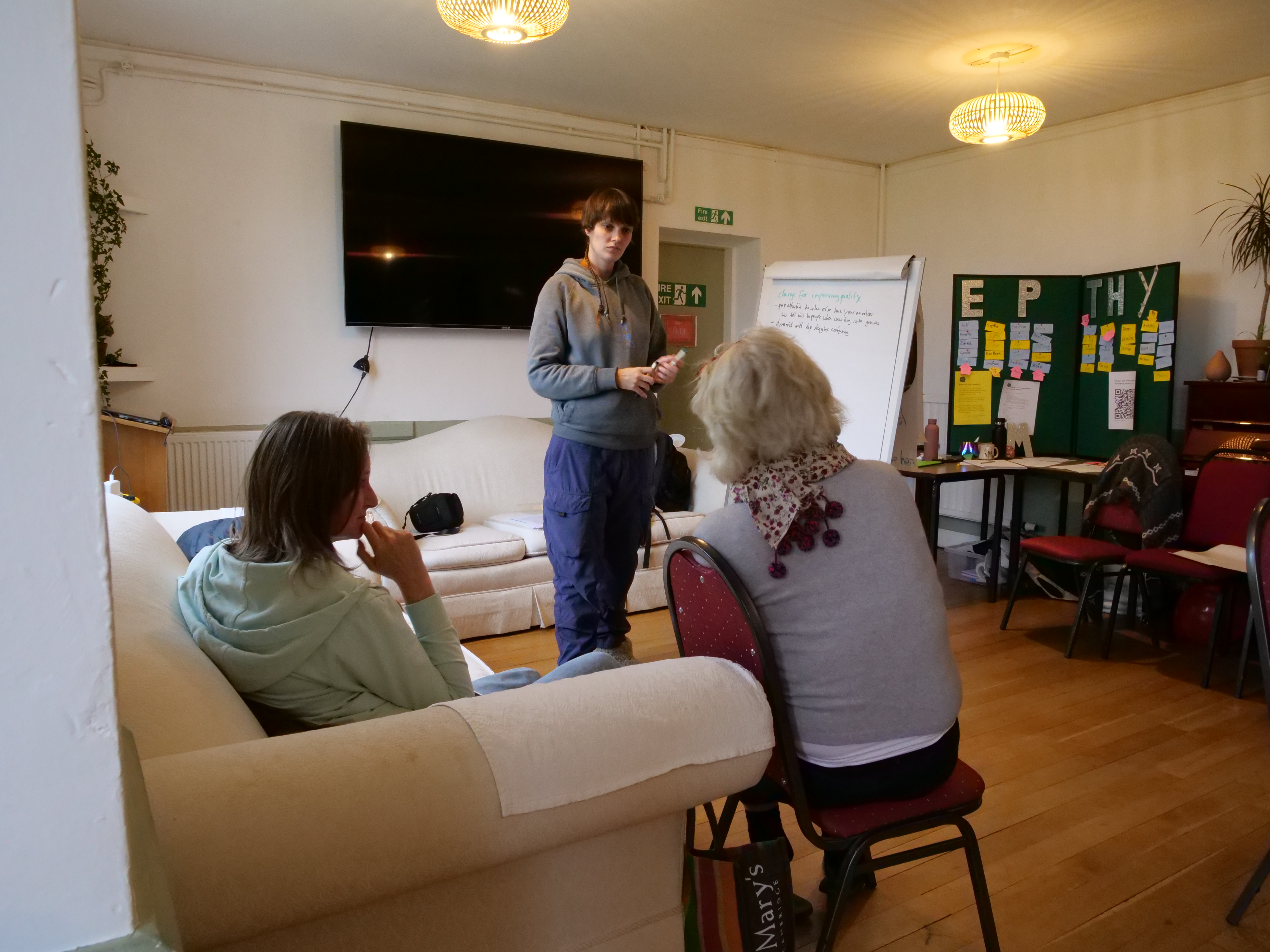 Kirstin standing next to a flipchart in front of a group