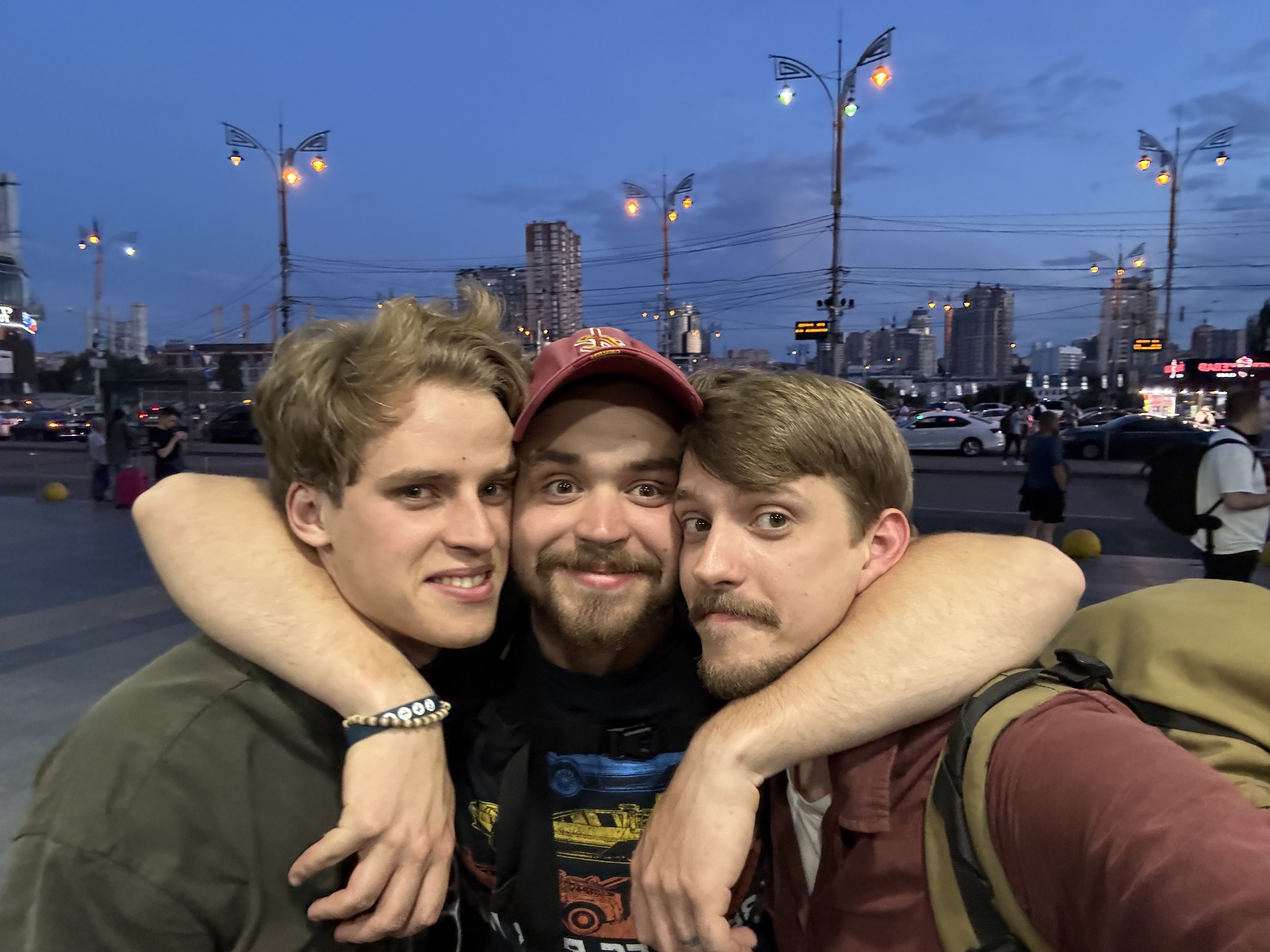 Kostia with Sasha and friends, arms around each other