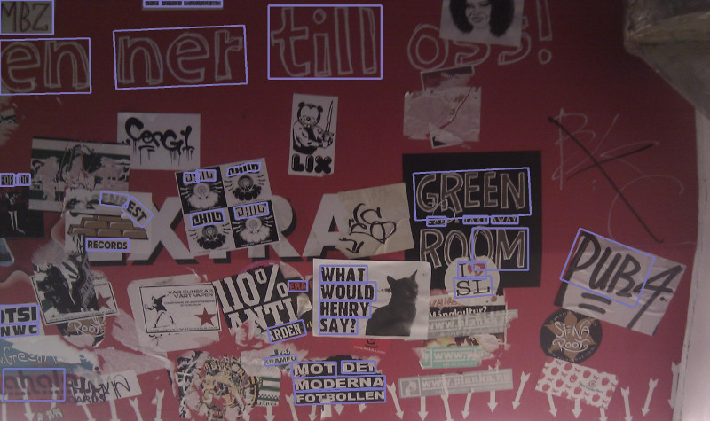 Photo of a board with many stickers and graffiti