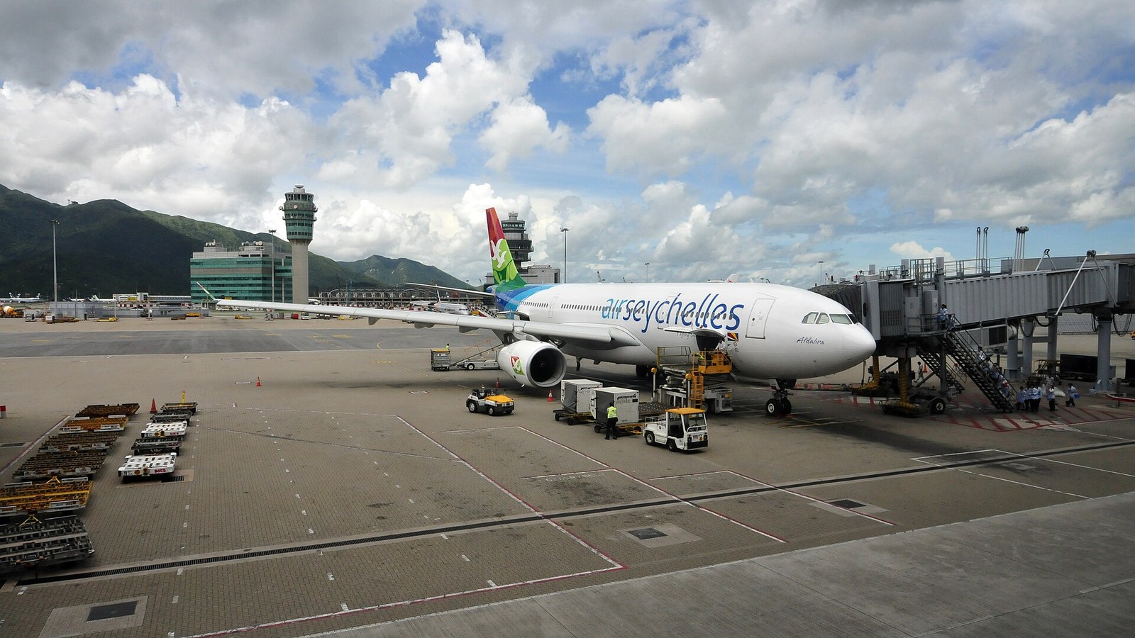 subject near 2000 words editorial photograph of airport check-in counters and baggage drop areas with travelers queuing