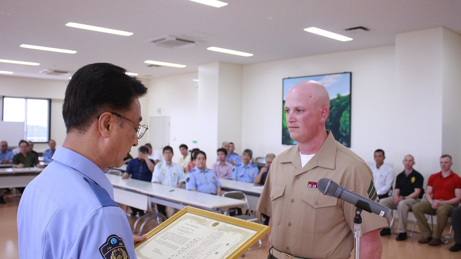 Illustrative photograph titled: Okinawa City Police recognize Marine for professionalism 130530-M-GE767-991