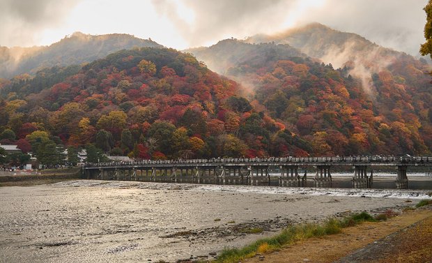 Togetsukyo Bridge in Arashiyama with the hills in autumn colour