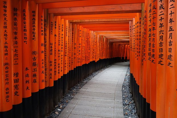 Empty Senbon Torii tunnel of orange gates at Fushimi Inari Taisha