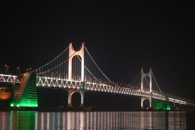Gwangan Bridge (광안대교) lit up at night over the sea at Gwangalli