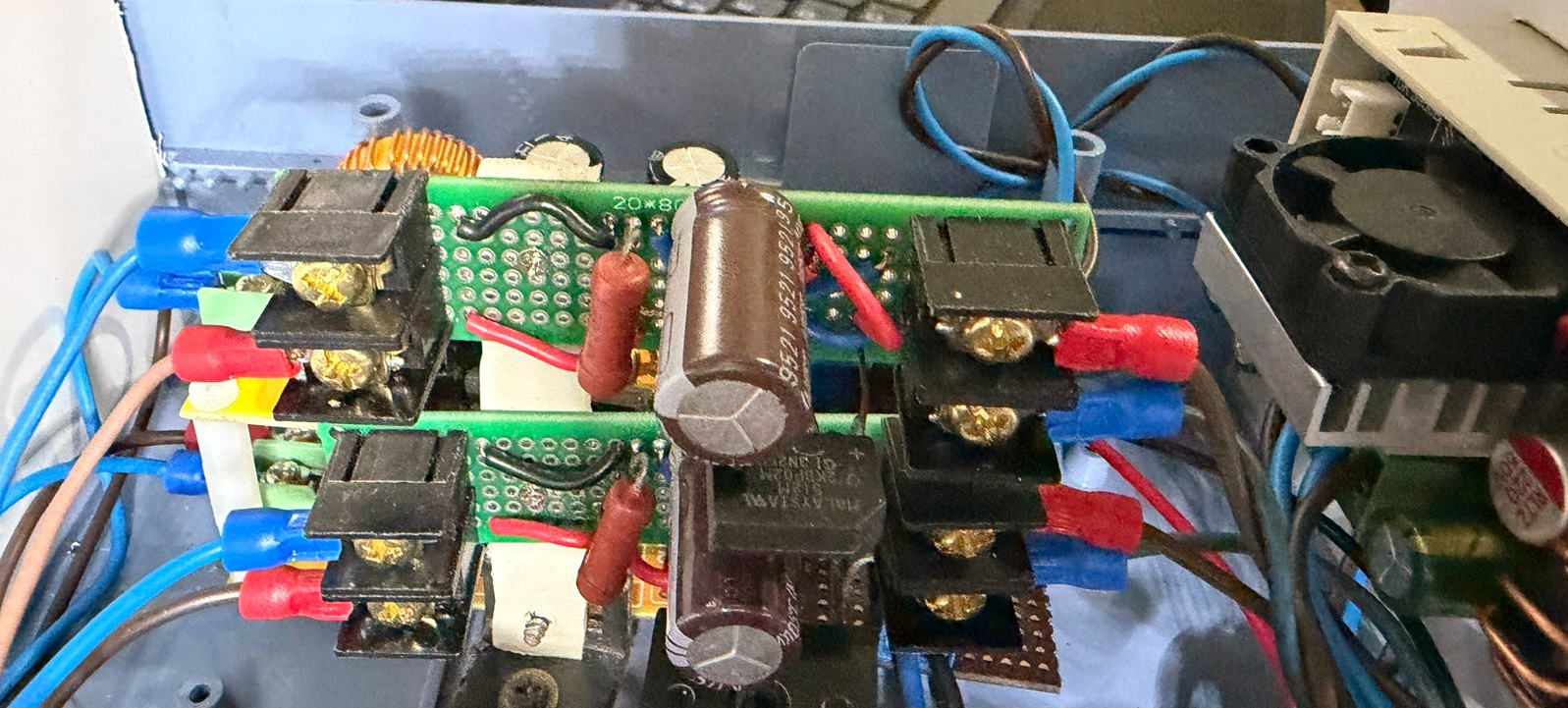 Two perfboard rectifiers: bridge packages, large electrolytics, bleeding resistors, terminal blocks