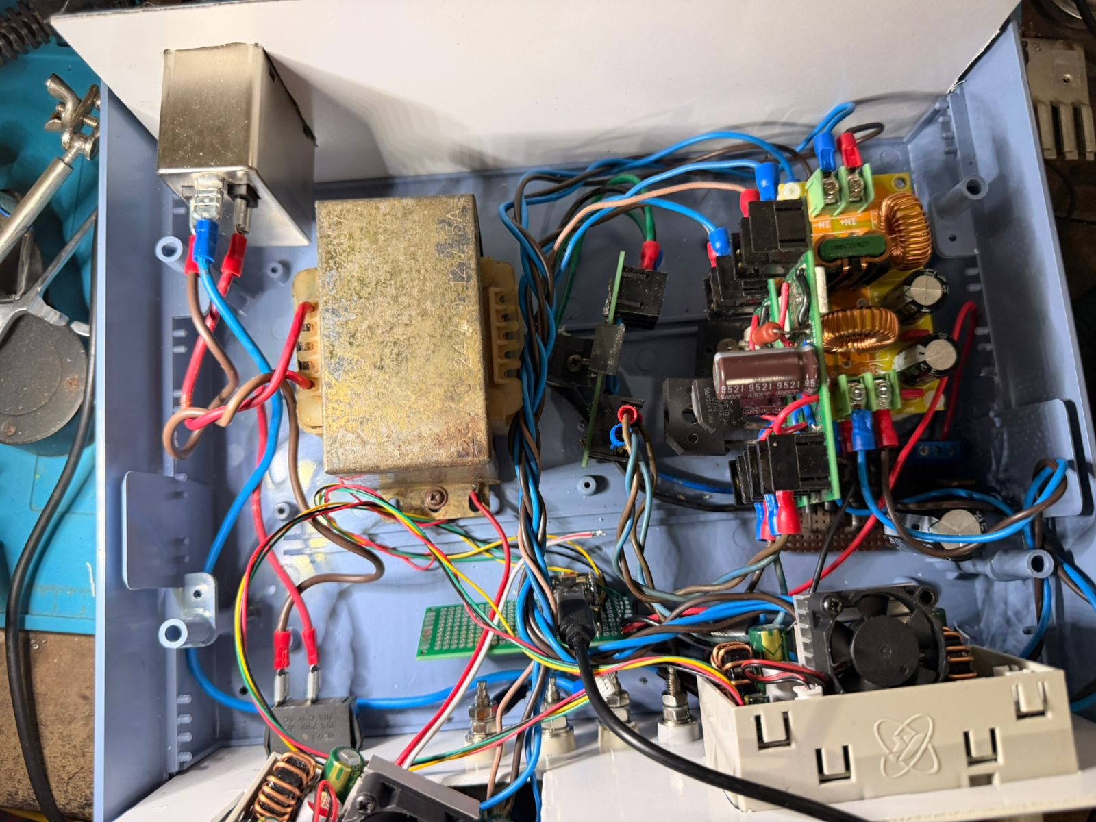 Interior mid-build: transformer, line filter, ESP32 super mini, filtering boards, dual SK120X modules, wiring in progress