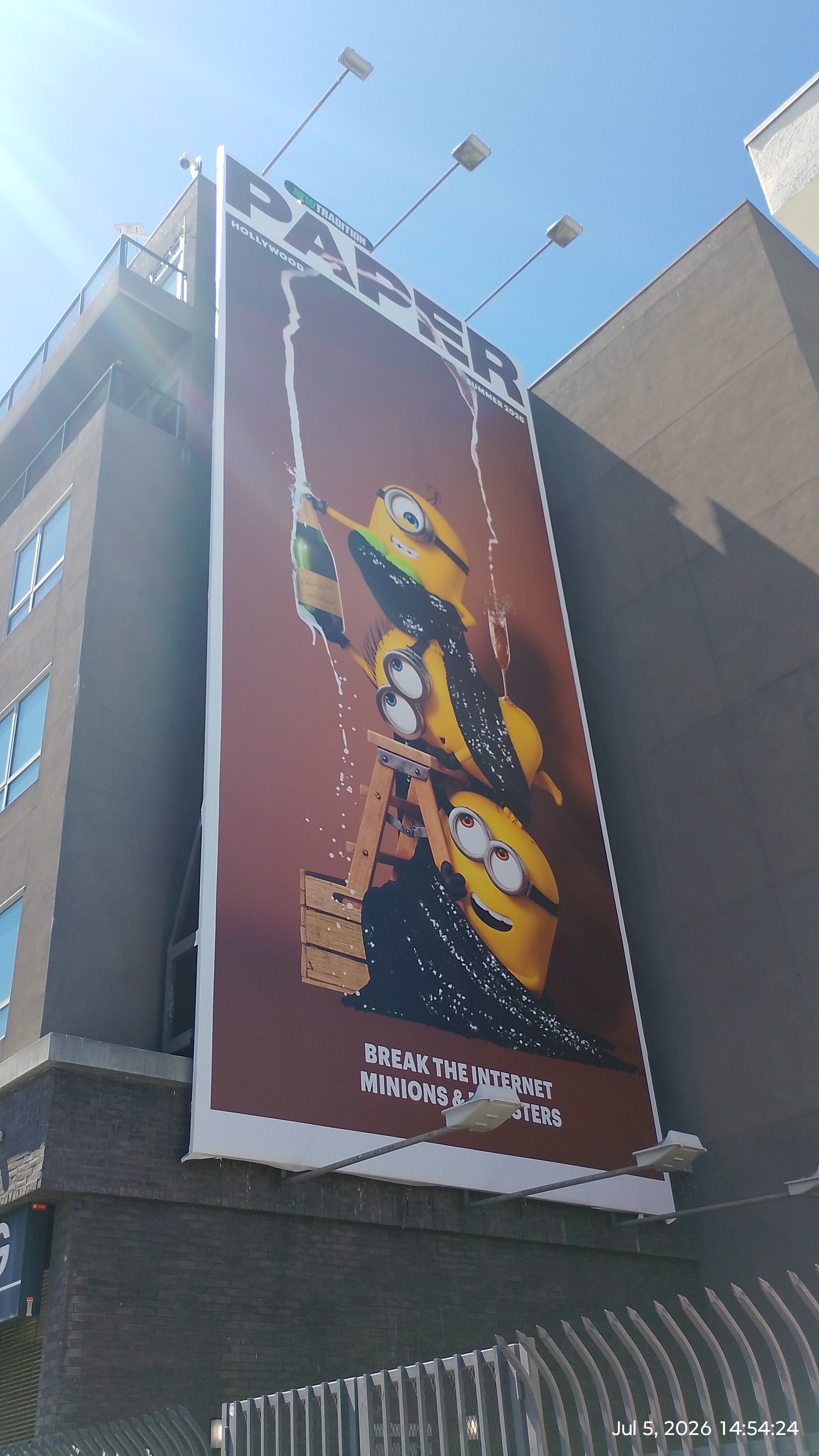 three minions pose like Kim Kardashian, champagne and all