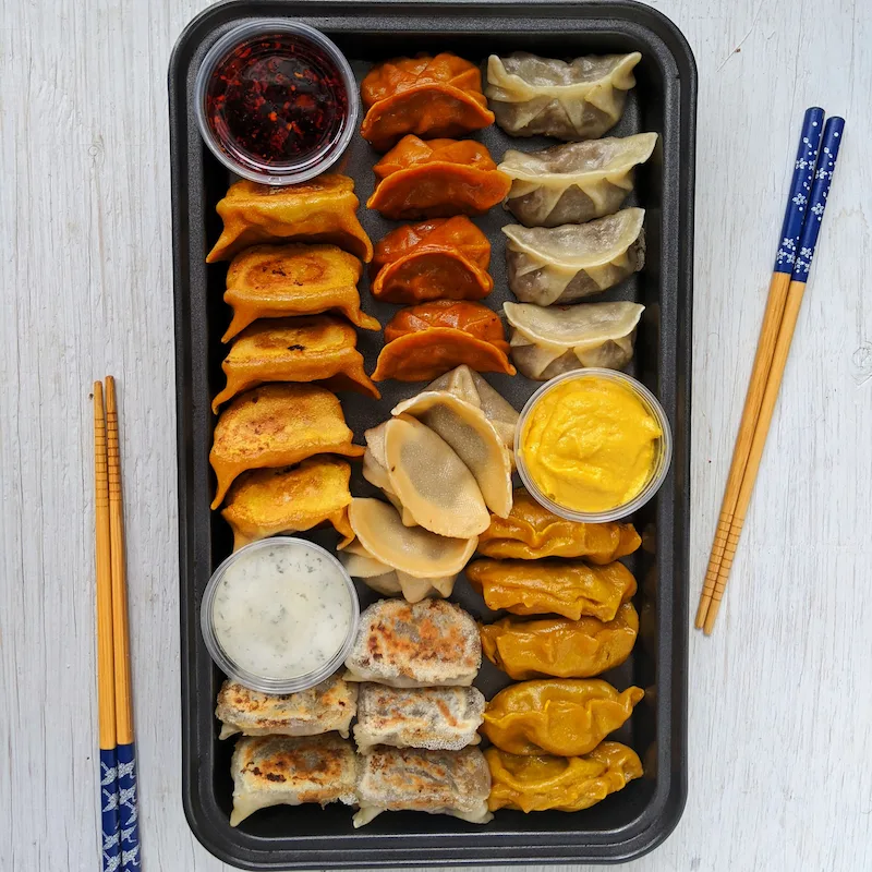 Assorted plant-based dumplings with dipping sauces