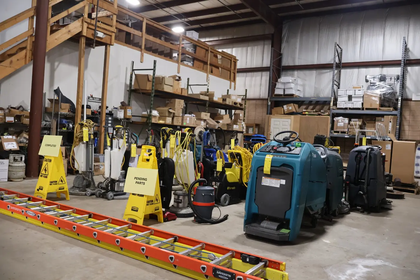 Lineup of commercial floor machines waiting in Action’s service area