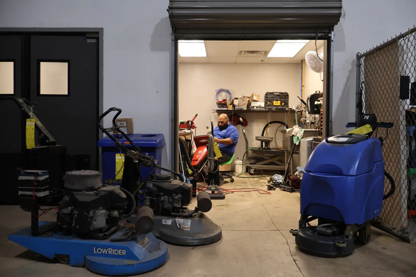 Action repair technician working in the commercial equipment repair bay