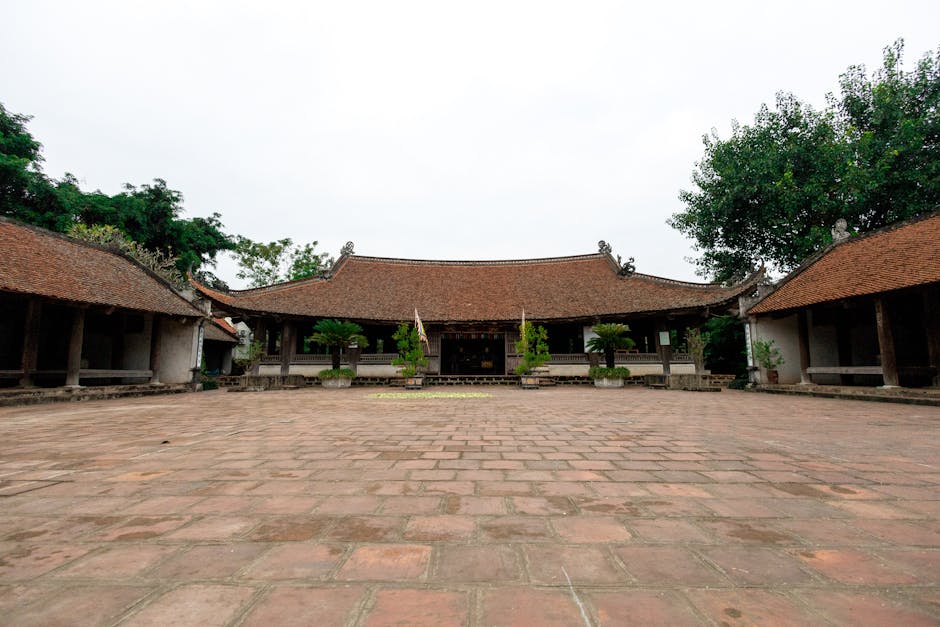 Explore the serene beauty of a traditional Vietnamese temple courtyard in Hà Nội, captured on a clear day.