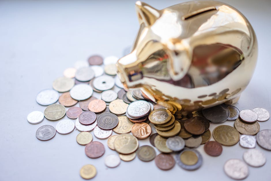 A golden piggy bank surrounded by assorted coins, symbolizing savings and wealth.