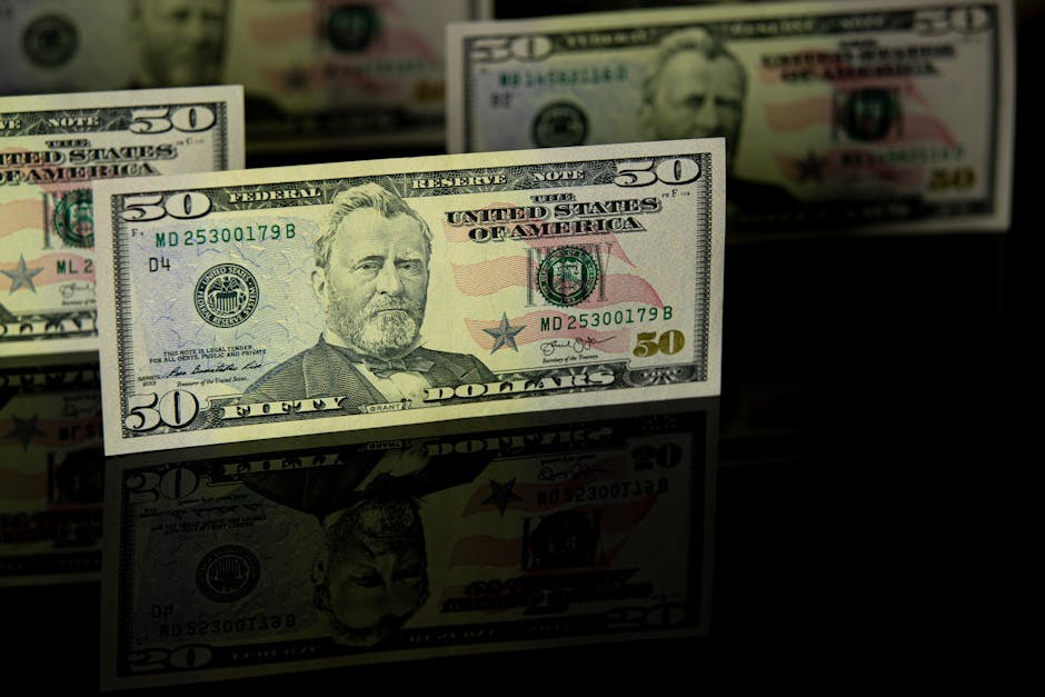 Crisp 50 dollar bill with reflection, offering a detailed view perfect for financial themes.
