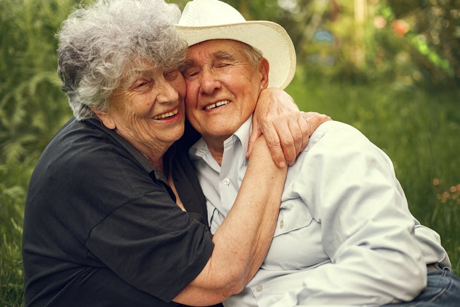 A joyful elderly couple hugging outdoors, exhibiting warmth and affection.