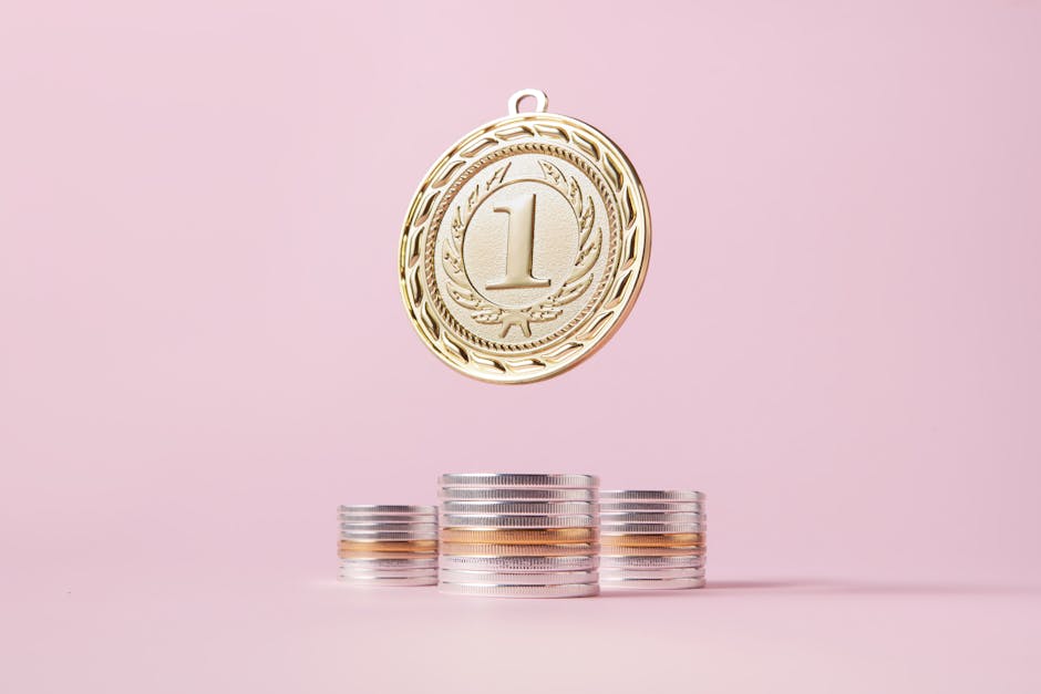 A gold medal and stacks of coins on a light pink backdrop, symbolizing victory and wealth.