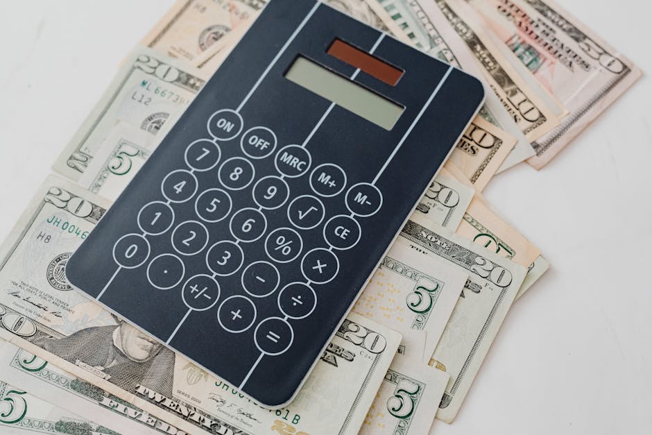 Close-up of a calculator atop US dollar bills, symbolizing financial planning and budgeting.