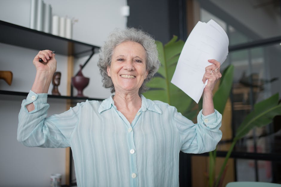 Joyful elderly woman holding documents inside an office setting, celebrating success.
